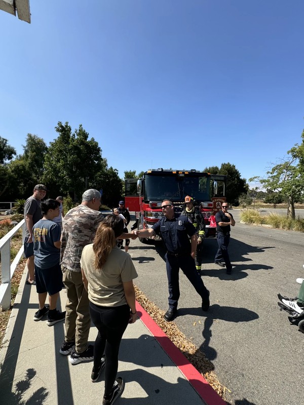 Adult day program group learning about community resources during educational visit with Oceanside fire department