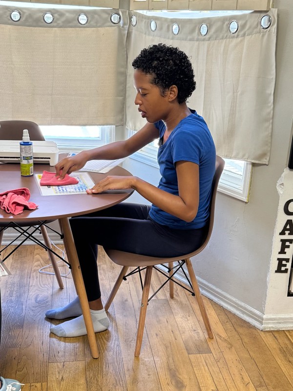 Female participant in Ivey's adult day program developing vocational office skills through hands-on administrative work and task completion at Ivey Ranch Park Association