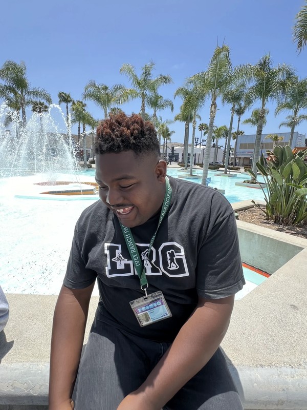 Adults with developmental disabilities participating in group community outing at recreational fountain area