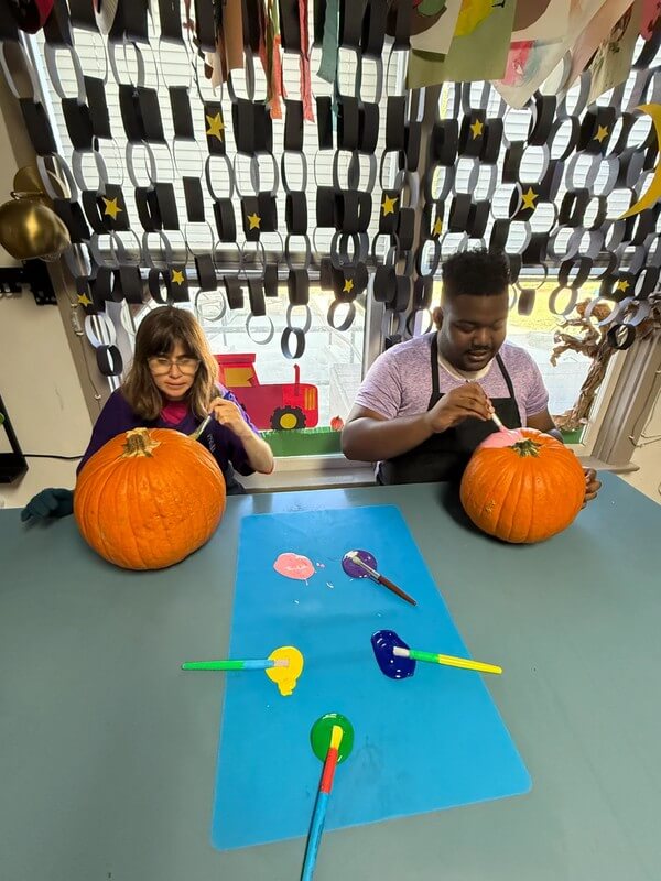 Adult carefully coloring festive holiday design with red and yellow markers