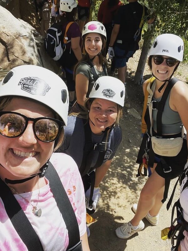 Ivey Ranch teachers participating in ziplining and outdoor team-building activities. Our staff's adventurous spirit and camaraderie translate to engaging programs for children.