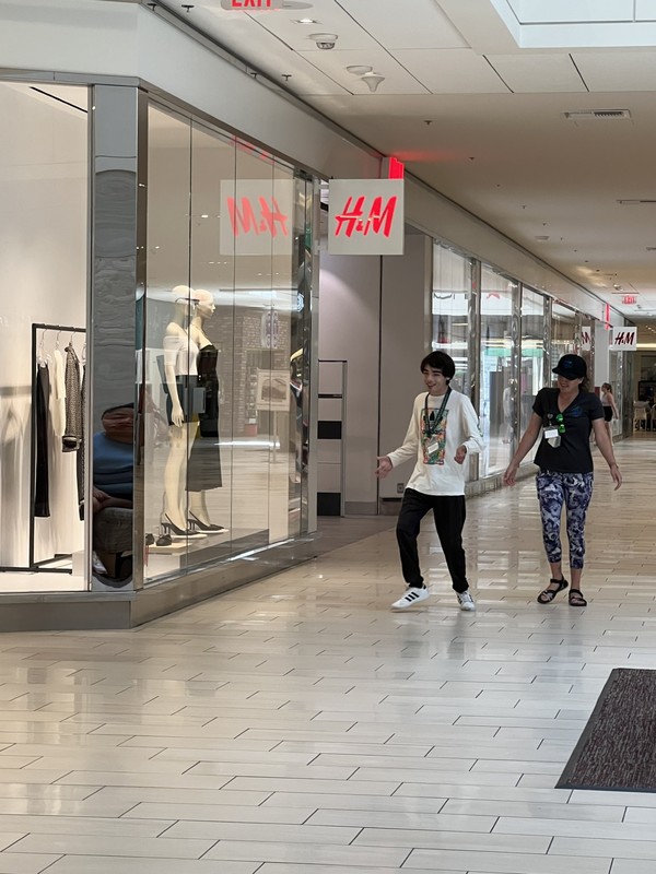 Adult day program staff and participants practicing shopping skills and store etiquette at H&M retail location