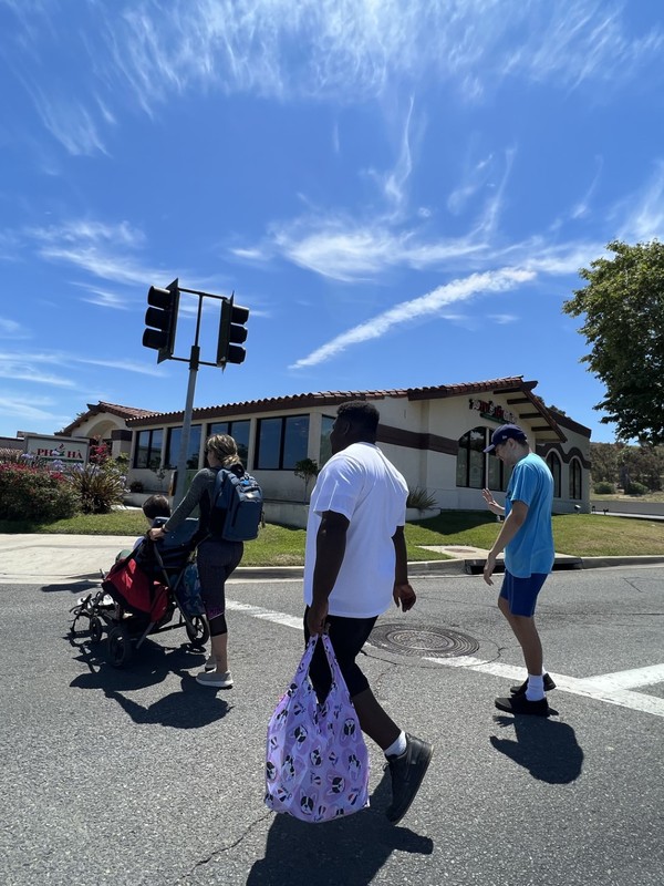 Adult day program participants practicing street safety and crosswalk skills during community outing in Oceanside