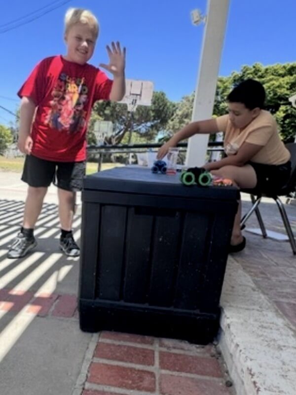 Children enjoying outdoor play and games during school-age care, promoting physical activity, social interaction, and cooperative play in supervised setting.