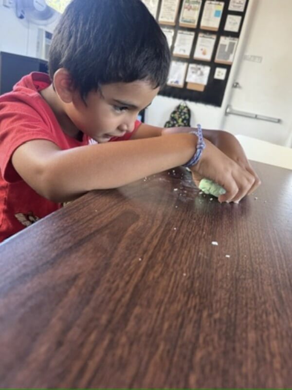 Boy engaged in creative play with play-doh