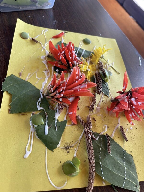 Beautiful nature-inspired craft using real flowers and leaves at after-school program, encouraging environmental awareness and artistic creativity.
