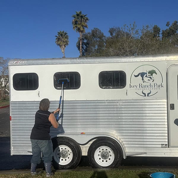TDS participant washing the Ivey Ranch horse trailer
