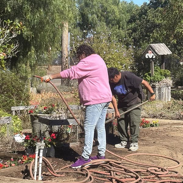 Two Ivey Ranch TDS participant working in the garden