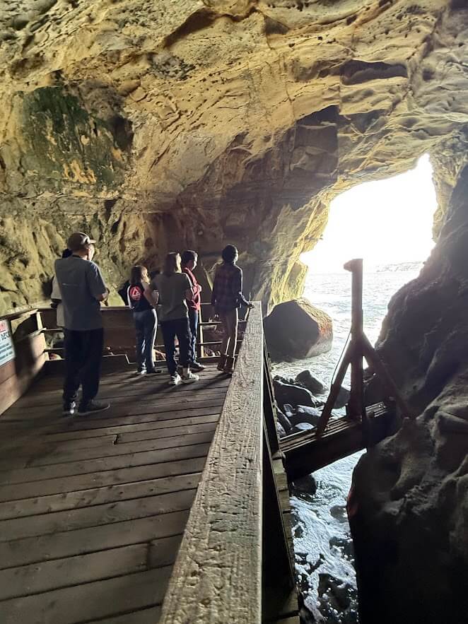 Ivey Ranch Adult Day Program participants exploring a sea cave walkway during a community outing in La Jolla