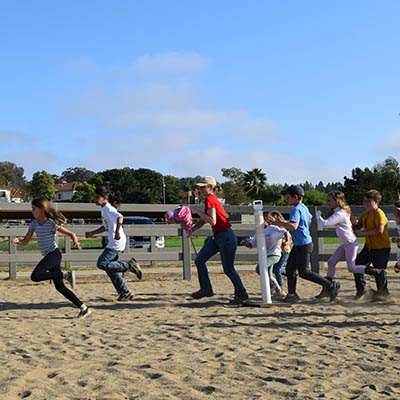 Children and staff enjoying games and activities during Chore n Smore at Ivey Ranch Park Association in Oceanside CA