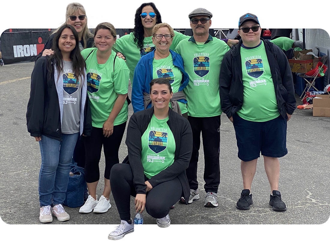 Ivey Ranch Park Association volunteers wearing green volunteer shirts at the IRONMAN Oceanside event