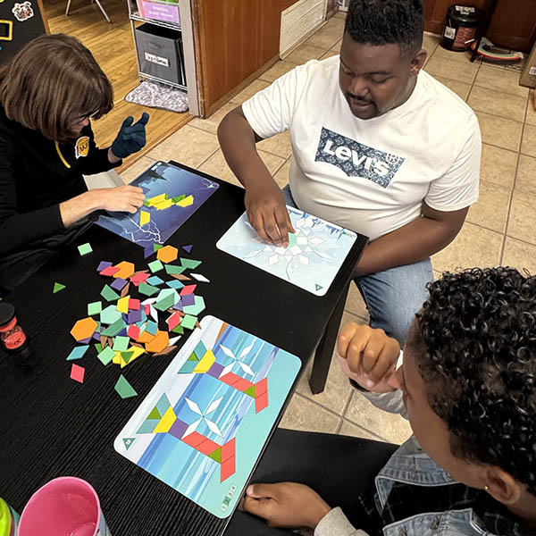 Out-of-home respite participants engaged in a group pattern block activity at Ivey Ranch in Oceanside, CA