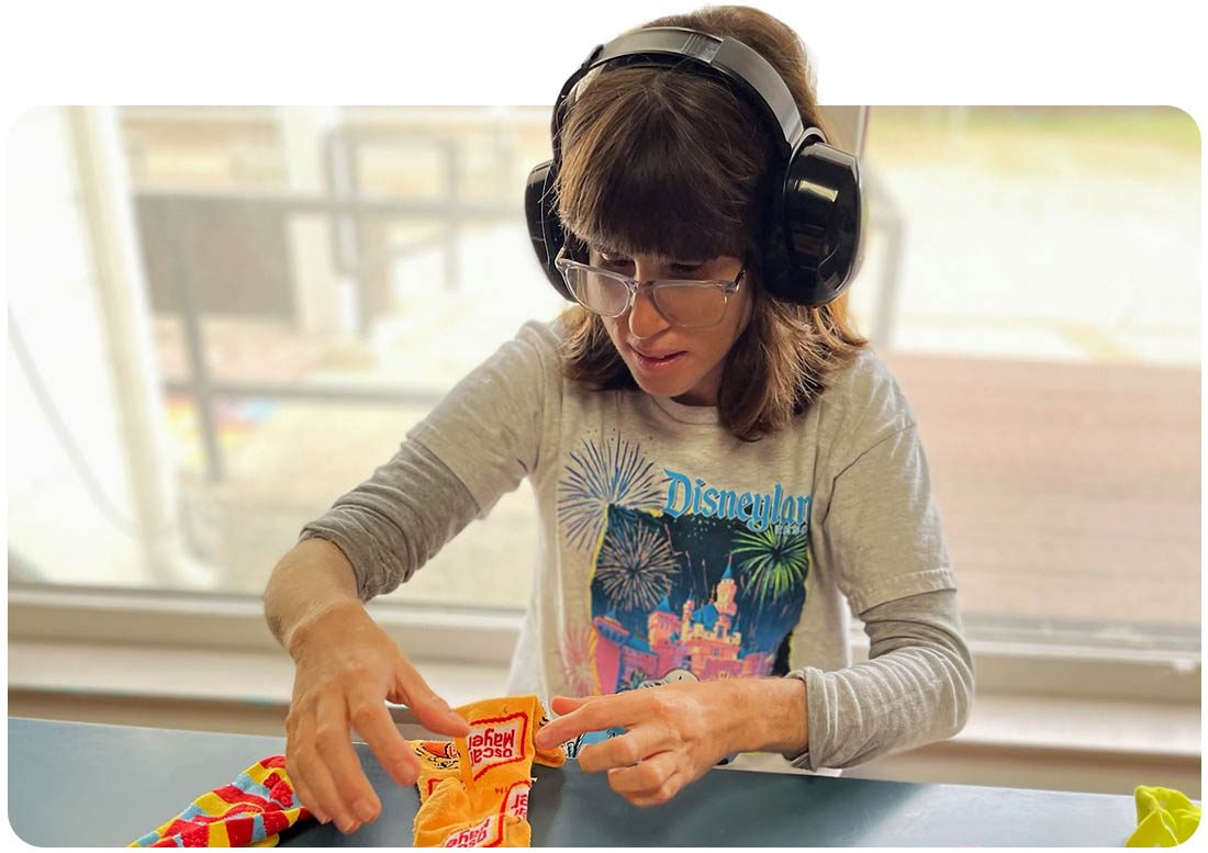 Respite program participant engaged in a skills activity at Ivey Ranch in Oceanside, CA