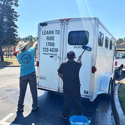 Tailored Day Service participants washing the Ivey Ranch horse trailer in Oceanside, CA