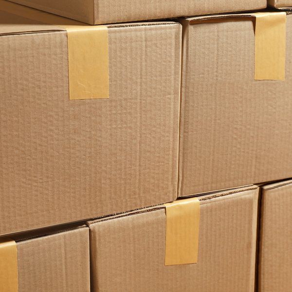 Stack of taped cardboard boxes representing Amazon wish list donations shipped to the Ranch