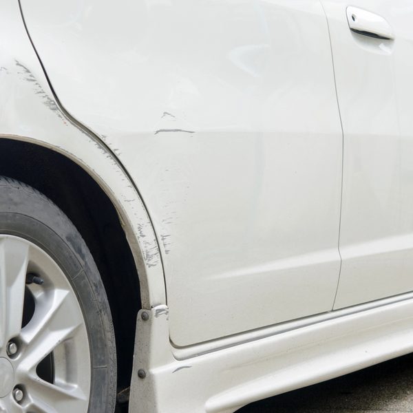 Close-up of a used car's dented fender, illustrating vehicles accepted for donation