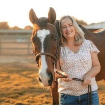 Volunteer Teri standing with retired thoroughbred Island at Ivey Ranch in Oceanside, CA