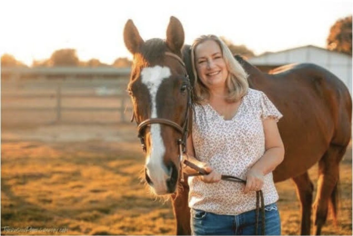 Volunteer Teri standing with retired thoroughbred Island at Ivey Ranch in Oceanside, CA